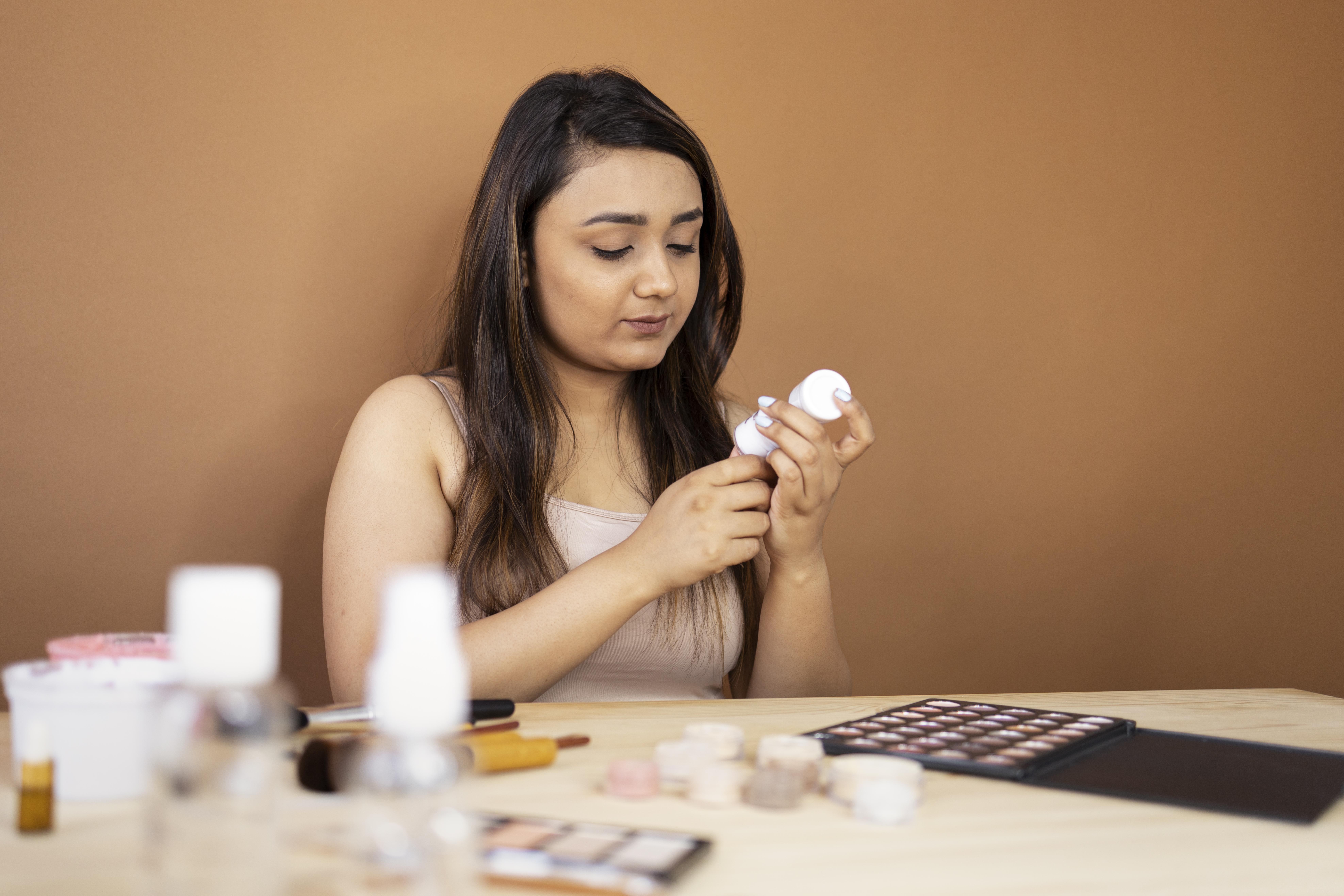 Person reading a skincare ingredient label